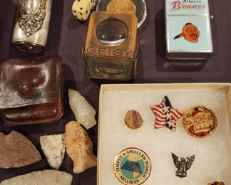 Lots of interesting small items. The sample above shows arrowheads, silver lighter cover, lapel pins, Atlanta Braves Lighter, dice & linen tester magnifier
