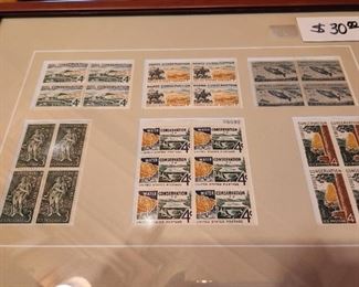 Framed 3 and 4 cent conservation stamps.