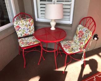 Red metal patio bistro table and chairs