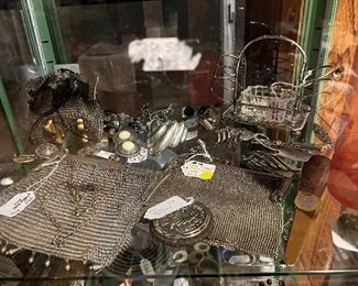 Unique silver items—rare antique toast rack with jam dish; silver mesh purses; compact, jewelry.