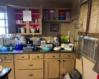 Lots of kitchen items. Cabinets, sink, stove refrigerator, window units, kitchen curtains 