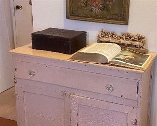 Sweet little chippy pink abinet, large print Bible, numerous religious icon art pieces