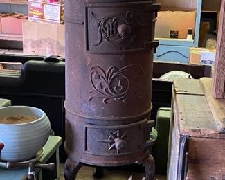 The cast iron ornamental has a stove top. It can be used for heat in a parlor as well. There is an opening in back to exhaust to the outside. 