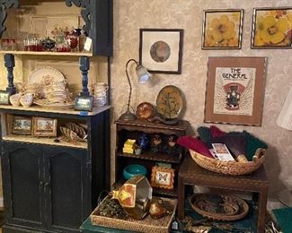 So many amazing treasures… unique blue cabinet made from antique doors - love the character of this piece, a green coffee table also made from antique doors, a swag hanging lamp - Italian Florentine in style, artisanal brooms, 70’s baskets, original floral art , the general silent film art poster beautifully framed