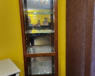 Curio cabinet with glass shelves. Side opening door