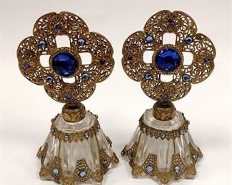  PAIR OF GLASS PERFUME BOTTLES WITH JEWELED FILIGREE STOPPERS . ONE HAS DAUBER BROKEN OFF. NICK ON ONE FOOT