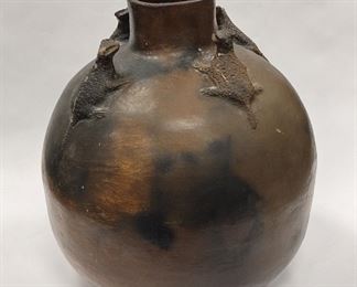 PRE-COLUMBIAN STYLE POTTERY JAR. HAS FOUR LIZARD/FROGLETS NEAR THE TOP. 12" TALL, 11" DIAMETER. ONE HEAD REPAIRED