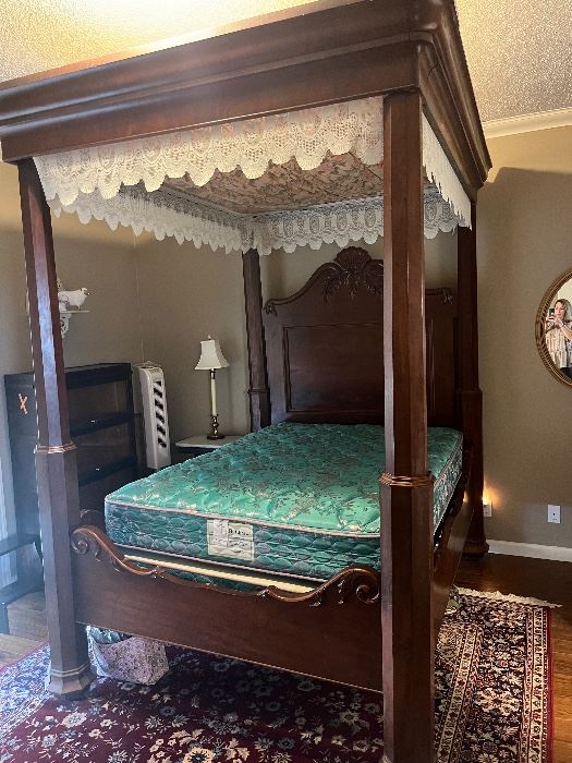 American Empire Transitional mahogany poster bed circa 1830s. Octagonal tapered corner posts, carved central medallion and scroll work on edge of head-board over an inset panel. 