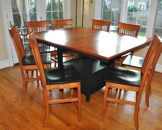 Larkin Gathering Table by L.J. Gascho Furniture with 8 Counter Height Chairs part of the Amish Craftsmen Collection. The dining table measures 54" x 42" and opens up to 66" with the 2-12" leaves.