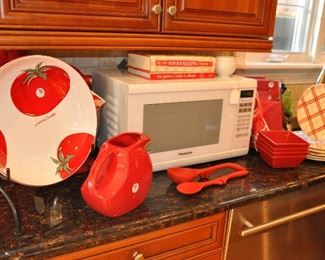 Great Fiesta Red Pitcher Shown with a Tomato Pasta Bowl Made in Portugal, a Panasonic Genius Sensor Microwave Oven Model # NN-SN651, an 11 Piece Set of Red Square Dinnerware Set by Ciroa, and a Set of 6 Dessert Plates by Matceramica