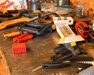 Assorted tools, nuts, bolts, camping supplies, and more