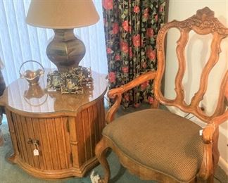 One of two armchairs, side tables, and lamps