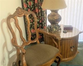 One of two armchairs, side tables, and lamps