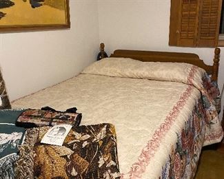 Full size  bed  with afghans on display!