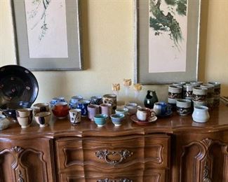 Buffet with lots of hand made cups, saucers and onyx candle holder