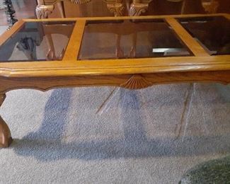 Glass and wood coffee table. Claw feet. 25 x 50 x 16. Matches lots 1001 and 1002