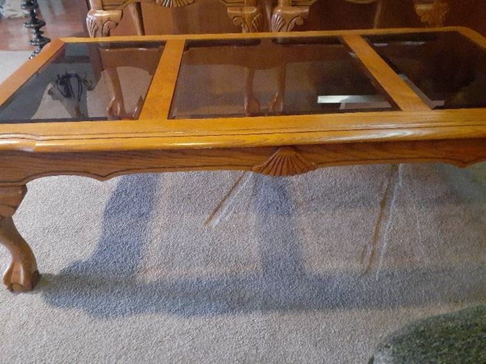 Glass and wood coffee table. Claw feet. 25 x 50 x 16. Matches lots 1001 and 1002