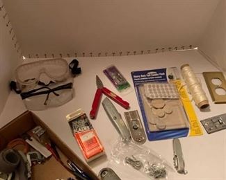 Miscellaneous items including furniture protector felt pads, string, razors, safety glasses, box cutter and knife, nails and more