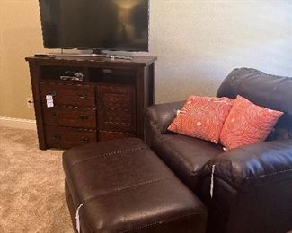 Oversized leather chair and ottoman.  Chest in the background is part of a complete bedroom set 
