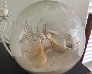 Glass World orb filled with sand and seashells 