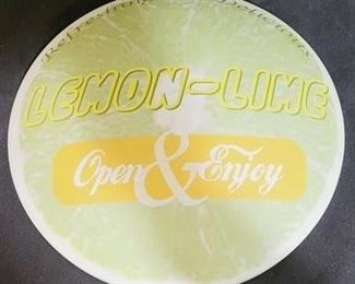 74 - 12" Metal lemon-lime button sign
