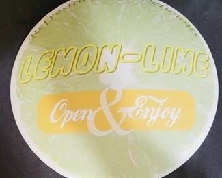76 - 12" Metal lemon-lime button sign
