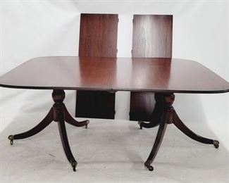 1538 - Mahogany Duncan Phyfe dining table, 2 leaves Brass toes & casters 29 x 69 x 49 without leaves, opens to 105"
