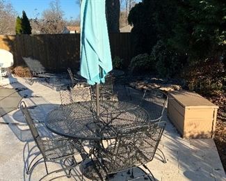 Wrought iron round table with rocker chairs & umbrella