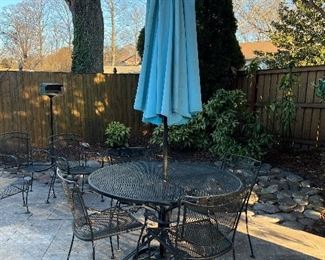 Wrought iron round table with 4 matching chairs, umbrella stand and umbrella