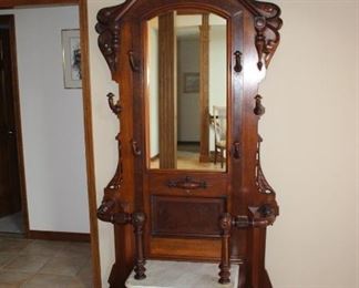 Ornate marble and walnut hall stand with mirror and hooks.  Excellent antique piece.
