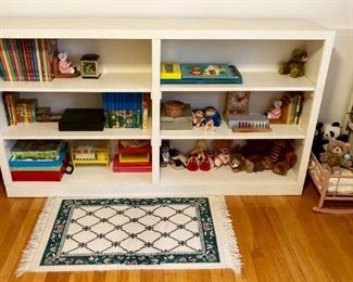 Double three-tiered book shelf, vintage wooden pink baby doll cradle with pillow, 23" x 40" area rug, vintage children's toys