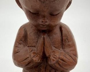 Vintage wooden praying child