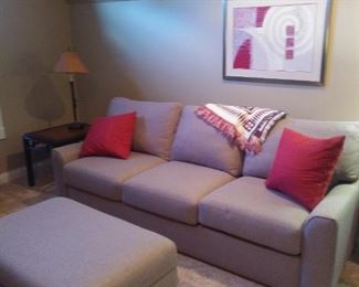 American Leather sleeper sofa with matching storage ottoman