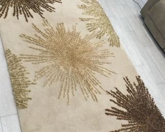 Black Bookshelf With A Wool Rug