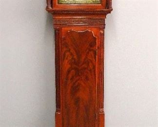 A late 18th century English grandfather clock.  8-day weight driven time and strike movement by "John Oliver, Manchester" with square Brass dial, Silvered chapter ring and cast spandrels, subsidiary seconds and date aperture.  Mahogany case with broken arch top, fluted columns, shaped waist door and shaped bracket base.  Lacks one return molding on hood, several edge chips and minor case damage, repaired dial, replaced base, running when cataloged.  90 1/2" high.  ESTIMATE $300-400
