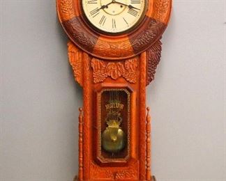 A 1980's reproduction "Regulator" wall clock.  8-day time and strike movement with papered metal dial and Brass lyre pendulum.  Carved Teak wood case with Brass dial door and rectangular lower with stenciled glass.  Minor wear, running when cataloged.  57" high.  ESTIMATE $200-300
