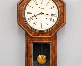 A late 19th century Welch "Verdi" model schoolhouse clock.  8-day time and strike movement with papered metal dial with Roman numerals and subsidiary seconds.  Rosewood veneered long drop case with octagon top and lower stenciled door.  Original finish with gilded detail, some wear, dial re-papered, running when cataloged.  31" high.  ESTIMATE $100-200
