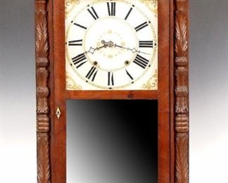 A 19th century Riley Whiting Empire shelf clock. 30-hr weight driven time and strike wooden movement with painted wooden dial and Roman numerals.  Mahogany case with a carved crest over single long door with clear upper, mirrored lower glass flanked by carved pilasters on a plinth base.  Paper label 70% intact.  Older refinishing with minor wear, some veneer damage, replaced crest and lower mirror, running momentarily when cataloged.  34 1/2" high.  ESTIMATE $100-150

