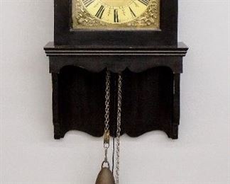 An 18th century 30-hr weight driven time and strike movement with Brass dial, cast spandrels, single Iron hand and Roman numerals.  In a custom made wall mounted case with removable hood and shaped drop, Black painted finish.  Minor wear, dial restored, running when cataloged.  29" high plus weight drop.  ESTIMATE $200-400
