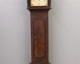 A 19th century American tall clock by Riley Whiting, Winchester, Conn (1807-1819).  30-hour weight driven time and strike wooden movement with a painted wood dial and Arabic numerals, subsidiary seconds and date dials marked "R. Whiting, Winchester".  Pine case with a broken arch top above a shaped dial door over a waist area with simple rectangular door and base with cut out skirt.  Original Brown painted finish with pin striped detail.  Some surface wear and minor paint loss, replaced weights, running when cataloged.   87" high.  ESTIMATE $400-600
