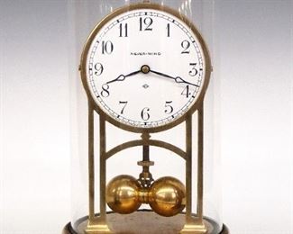 An early 20th century "Never-Wind" clock by the Cloister Clock Co.  Long running battery movement with porcelain dial and Arabic numerals with torsion pendulum. Brass frame and base with a glass dome.  Some corrosion, flake in dome, not running.  13" high overall.  ESTIMATE $50-75
