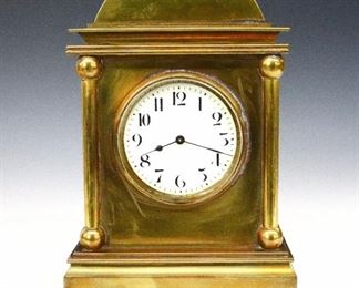A late 19th century French Brass desk clock.  8-day time only movement with platform escapement with a porcelain dial and Arabic numerals, winds from the back.  Heavy Brass case with arched top over a molded cornice and four turned columns on a molded base with bun feet.  Some wear to finish, running when cataloged.  10 1/2" high.  ESTIMATE $400-600
