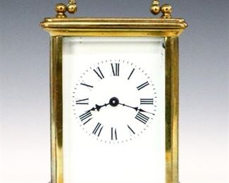 A turn of the century French Carriage clock.  8-day time only movement with platform escapement, a porcelain dial and Roman numerals faintly marked "R. P. Thorn & Sons...N.Y.".  Molded Brass case with beveled glass panels.  Some wear, running momentarily when cataloged.  4 3/4" high.  ESTIMATE $300-400

