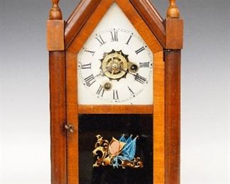 A 19th century E. N. Welch "Sharp Gothic" model miniature Steeple clock.  30-hr time and alarm movement with a painted metal dial and Roman numerals.  Mahogany case with turned finials, single door with clear dial glass and reverse painted lower.  Paper label 80% intact.  Good old finish with minor wear, some dial flaking, running when cataloged.  15" high.  ESTIMATE $300-500
