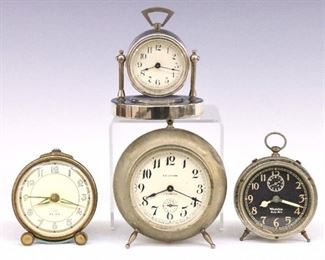 Four small 20th century alarm clocks including a Waterbury "Gale" model and three Westclox "Big Ben" models.  Some with minor damage and discoloration, Waterbury lacking feet, not tested, sold as-is.  Up to 6" high.  ESTIMATE $100-200
