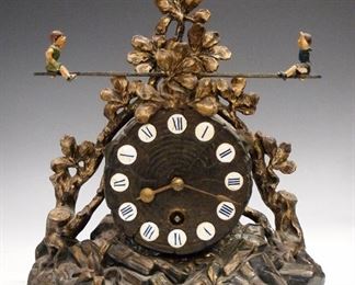 A turn of the century German Cast Iron novelty clock with Teeter-Totter automaton, possibly Lenzkirch.  30-hour time only movement.  Minor finish wear, running when cataloged.  9" high overall.  ESTIMATE $100-200