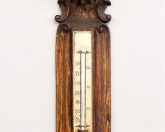 A turn of the century Black Forest thermometer.  Carved Oak with Lion's mask top and lower thermometer.  Old finish with some wear.  19" high.  ESTIMATE $100-200