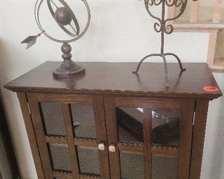 Smalle of two of set wood and glass panelef curio cabinets.