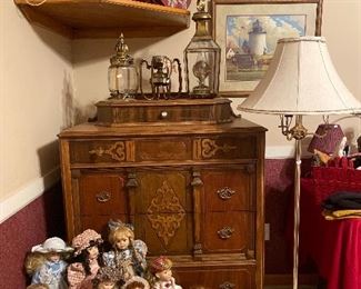 Vintage dresser- collectible dolls, hat boxes and floor lamp and well and antique lamps  