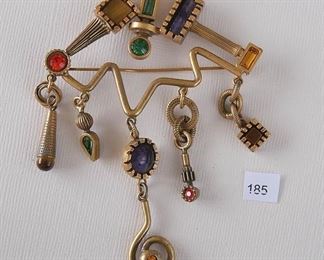 Patricia Locke - gold tone. 2 13/16” x 4 1/16”. 